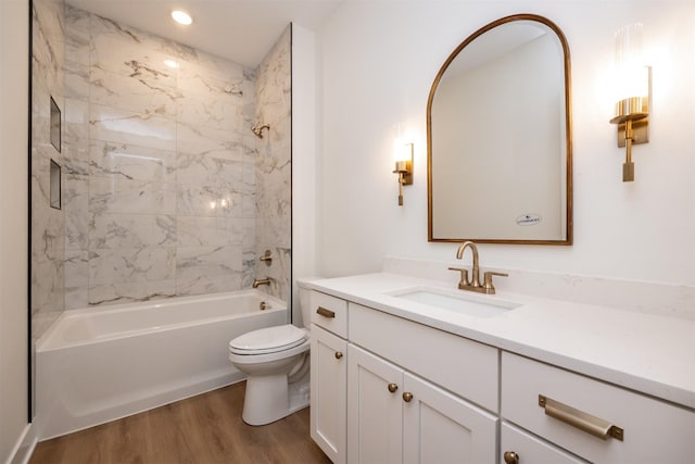 full bath featuring toilet, wood finished floors, vanity, washtub / shower combination, and recessed lighting