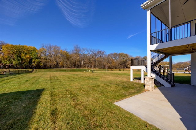 view of yard featuring a patio area and stairs