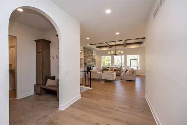 hallway with recessed lighting, visible vents, light wood-style flooring, and baseboards