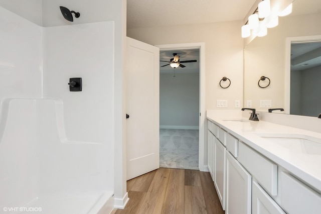 bathroom with vanity, hardwood / wood-style floors, and a textured ceiling