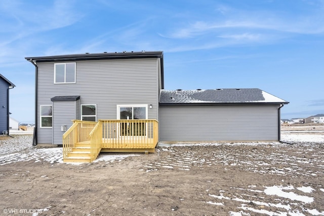 snow covered property featuring a deck