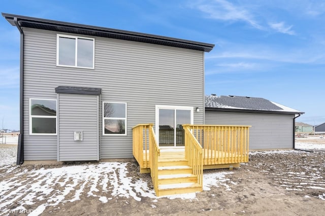 snow covered property featuring a wooden deck