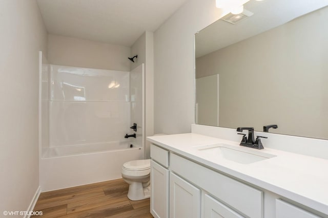 full bathroom with vanity, wood-type flooring, bathing tub / shower combination, and toilet