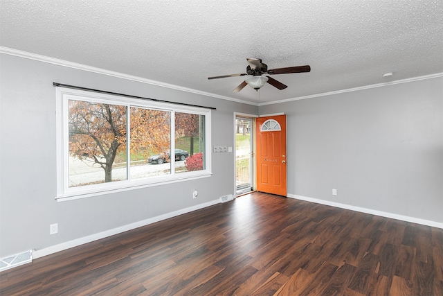 empty room featuring crown molding, plenty of natural light, ceiling fan, and dark wood-type flooring