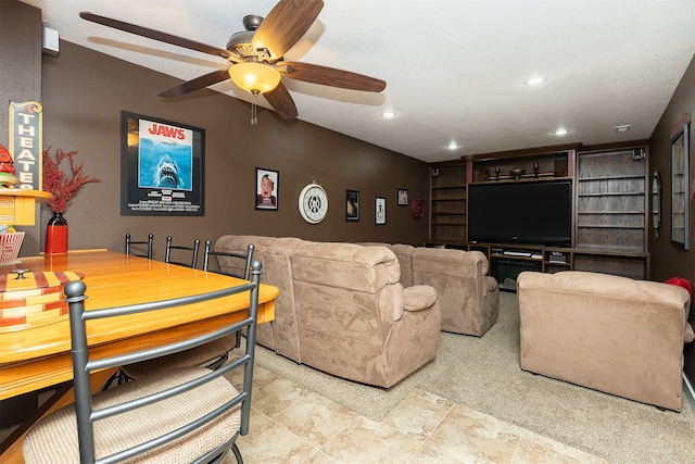 living room featuring ceiling fan and a textured ceiling