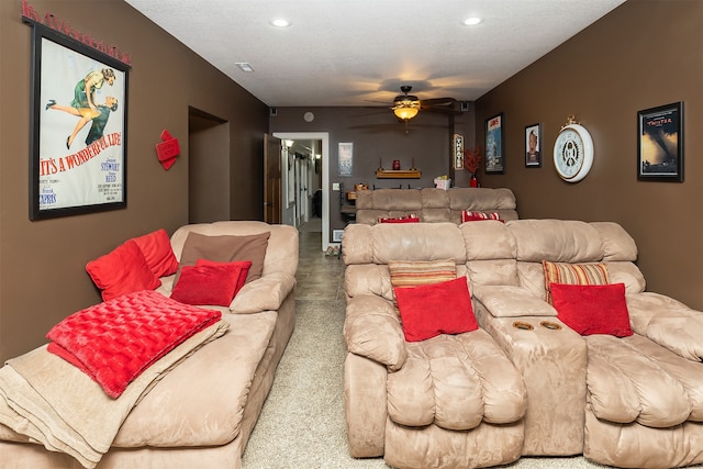 home theater featuring ceiling fan, carpet flooring, and a textured ceiling