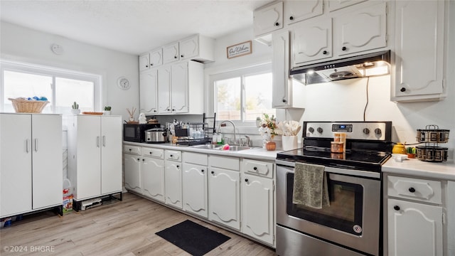 kitchen with white cabinetry, stainless steel electric range, sink, and light wood-type flooring