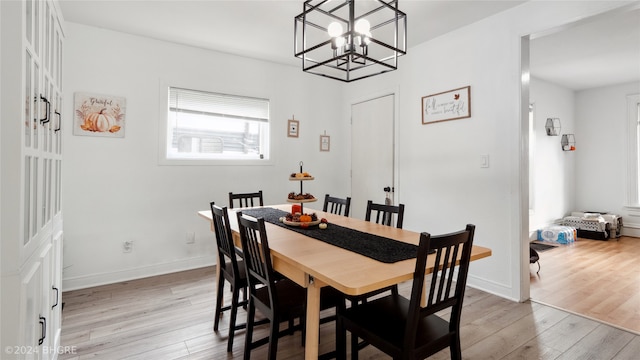 dining space featuring a chandelier and light hardwood / wood-style flooring