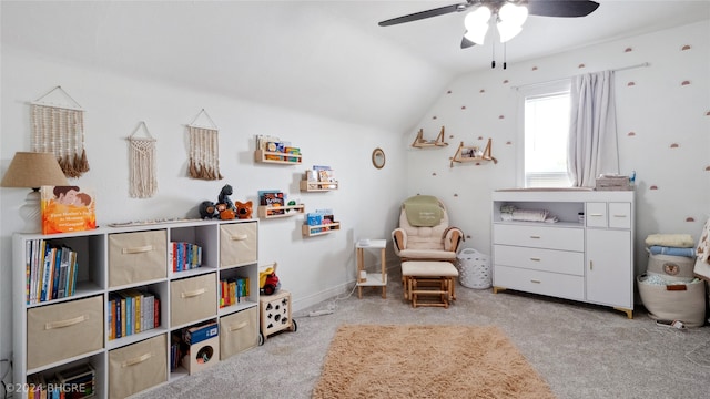 sitting room featuring light carpet, vaulted ceiling, and ceiling fan