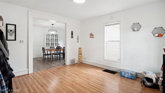803 W Nevada St, Marshalltown, IA 50158 - dining room with a chandelier, wood finished floors, and baseboards