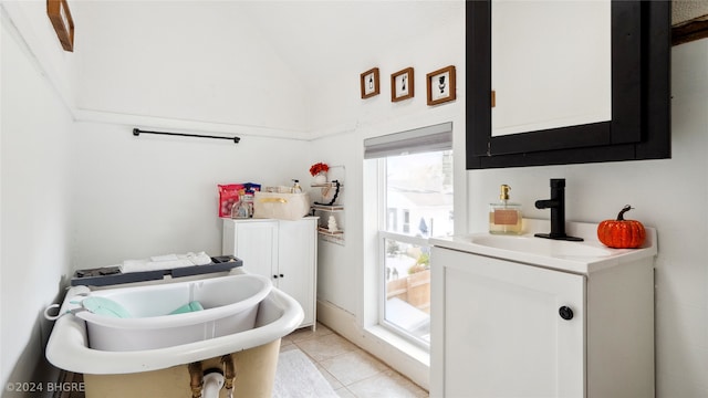 bathroom featuring a bath, tile patterned floors, and vanity