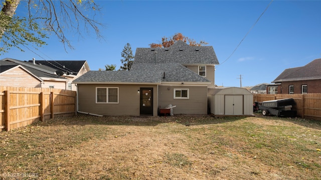 back of property featuring a shed and a lawn