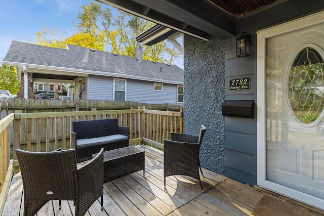 wooden terrace with fence and an outdoor living space