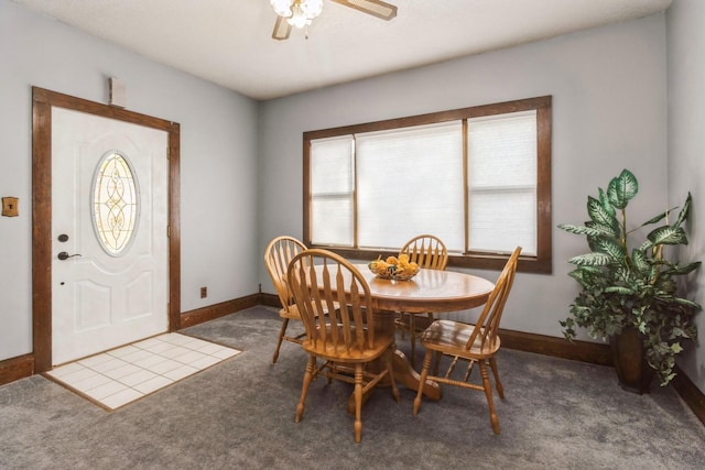 carpeted dining space with baseboards