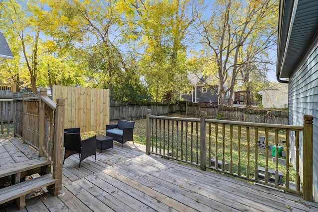 wooden deck with a fenced backyard