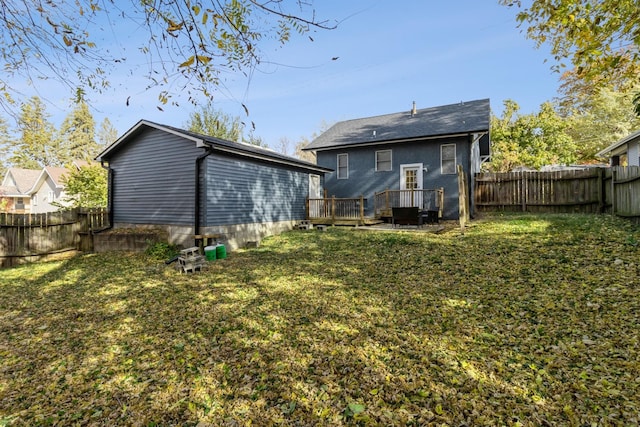 back of house featuring a fenced backyard, a wooden deck, and a yard