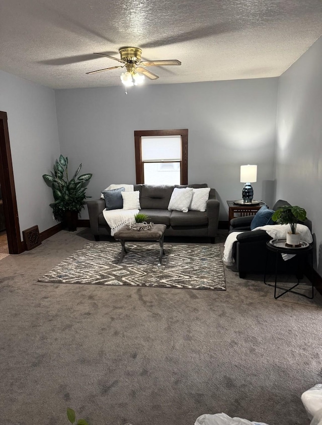 living area featuring a textured ceiling, carpet floors, and ceiling fan