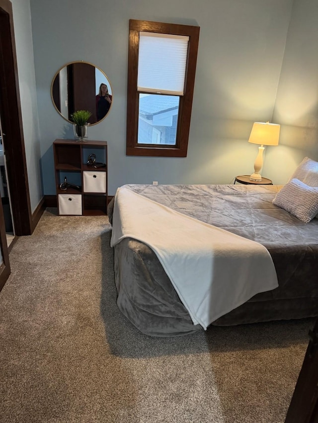 carpeted bedroom featuring baseboards