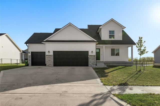 view of front of property with a front yard and a garage