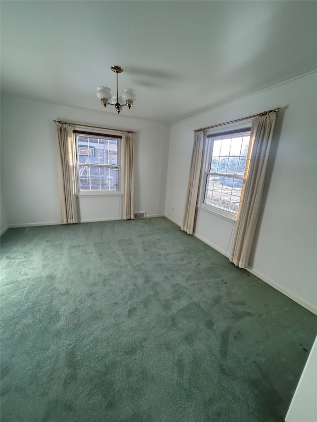 empty room featuring carpet and a chandelier