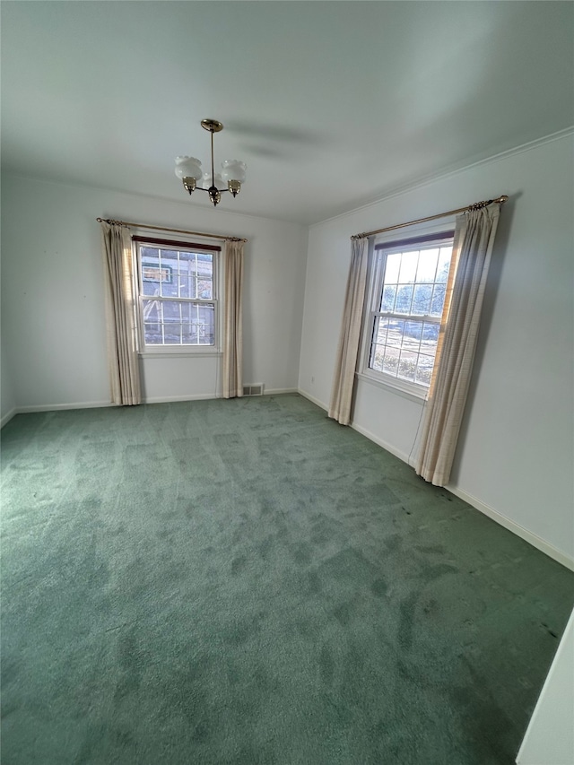 carpeted spare room with visible vents, baseboards, and a chandelier