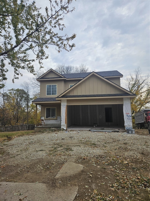 view of front of property featuring covered porch and a garage