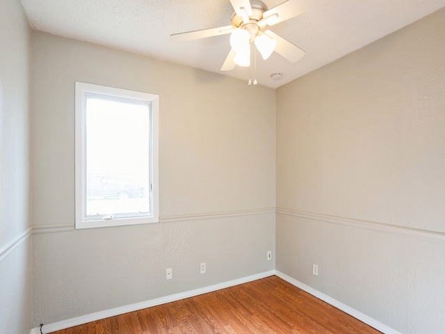 unfurnished room with hardwood / wood-style floors and ceiling fan