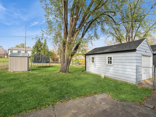 view of yard with a shed and a trampoline