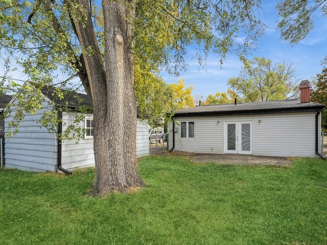 view of yard featuring a patio area and french doors