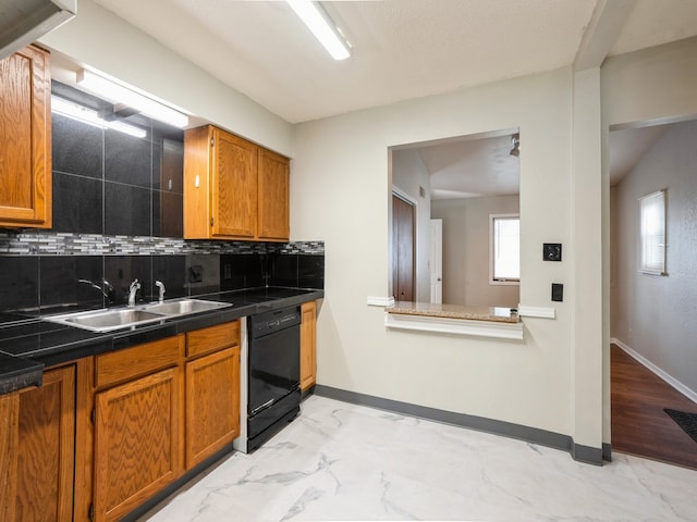 kitchen with black dishwasher, sink, backsplash, and light hardwood / wood-style floors