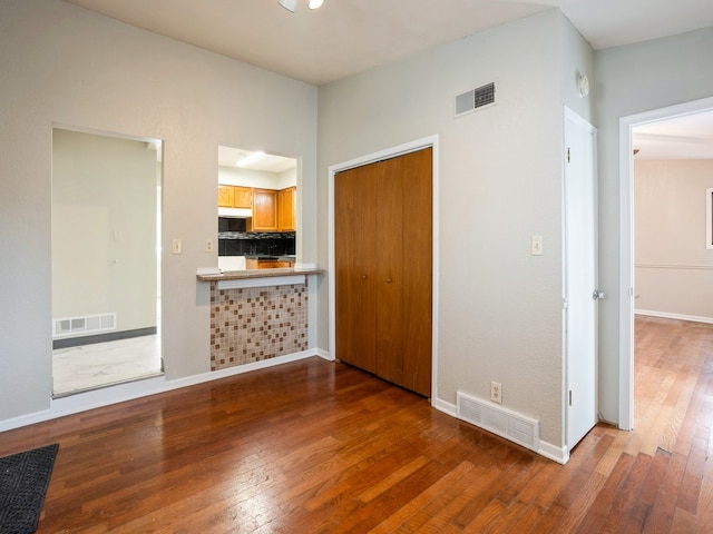 unfurnished bedroom featuring a closet and dark wood-type flooring