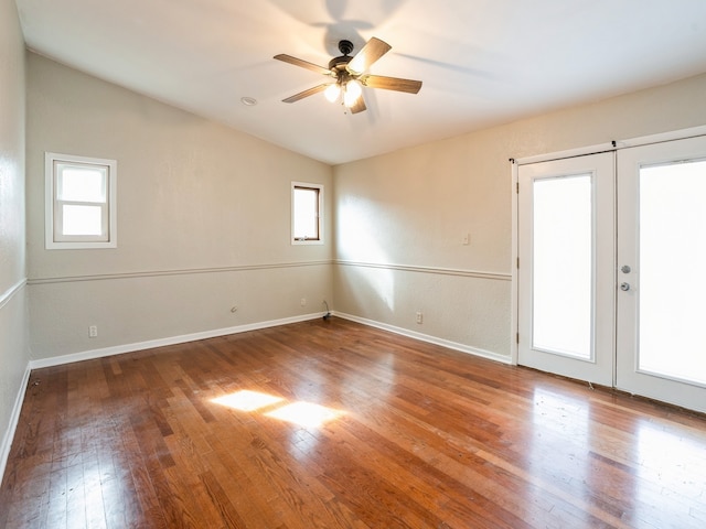 spare room featuring hardwood / wood-style floors, lofted ceiling, french doors, and ceiling fan