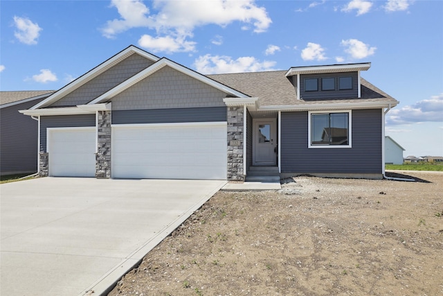 732 NE Deerfield Dr, Ankeny, IA 50021 - view of front of property featuring an attached garage, concrete driveway, and stone siding