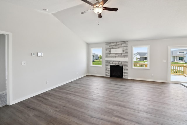 732 NE Deerfield Dr, Ankeny, IA 50021 - unfurnished living room with a ceiling fan, dark wood-style flooring, vaulted ceiling, a stone fireplace, and baseboards