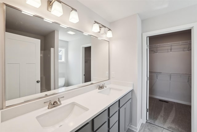 732 NE Deerfield Dr, Ankeny, IA 50021 - bathroom with toilet, double vanity, and a walk in closet