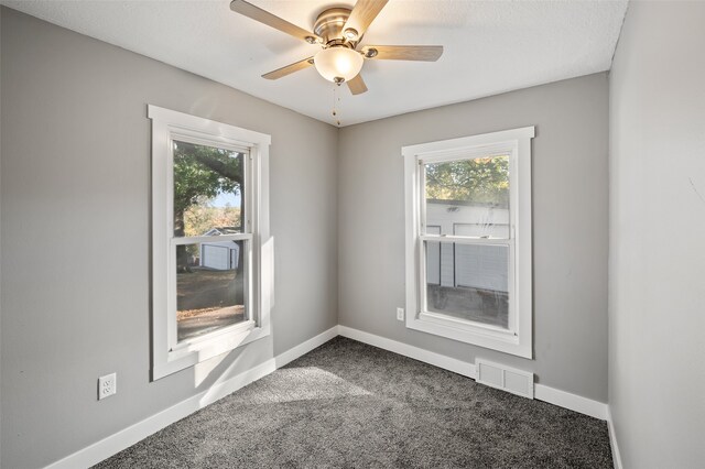 spare room with ceiling fan, a healthy amount of sunlight, carpet flooring, and a textured ceiling