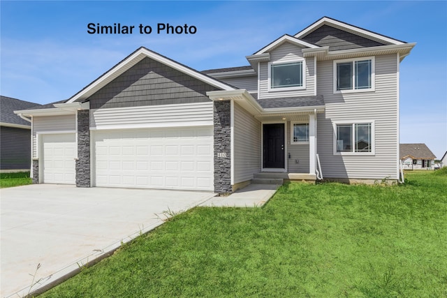 view of front of property featuring a garage and a front yard