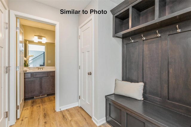 mudroom featuring light hardwood / wood-style flooring and sink