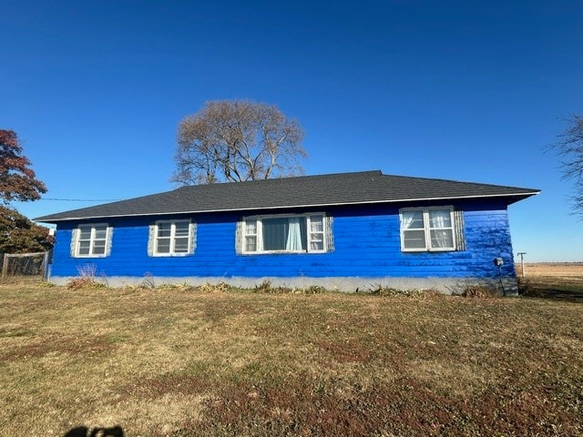 view of side of home featuring a yard