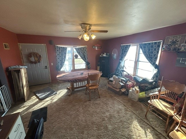 dining space with carpet and ceiling fan