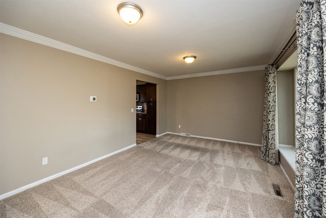 carpeted empty room with ornamental molding