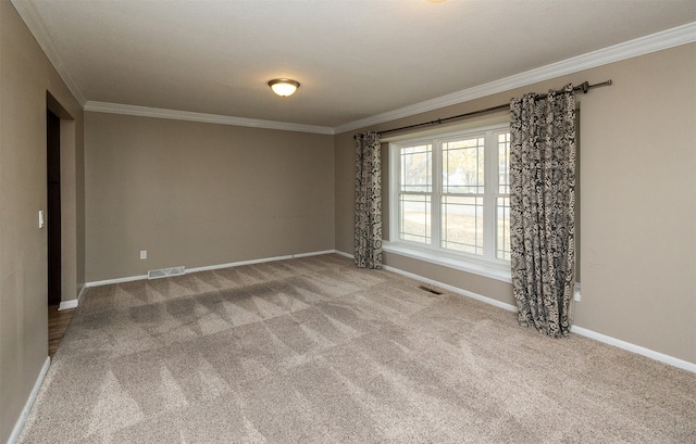 empty room featuring crown molding and light colored carpet