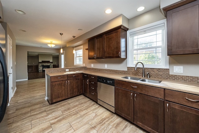 kitchen featuring sink, a healthy amount of sunlight, dark brown cabinets, and dishwasher