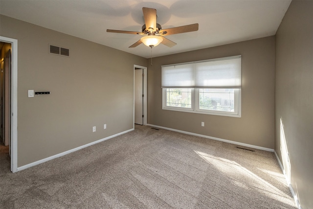 unfurnished room with carpet floors and ceiling fan