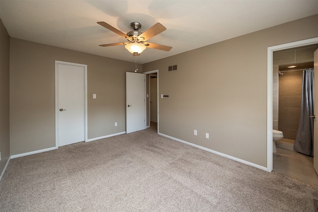 unfurnished bedroom featuring ceiling fan, ensuite bath, and light colored carpet