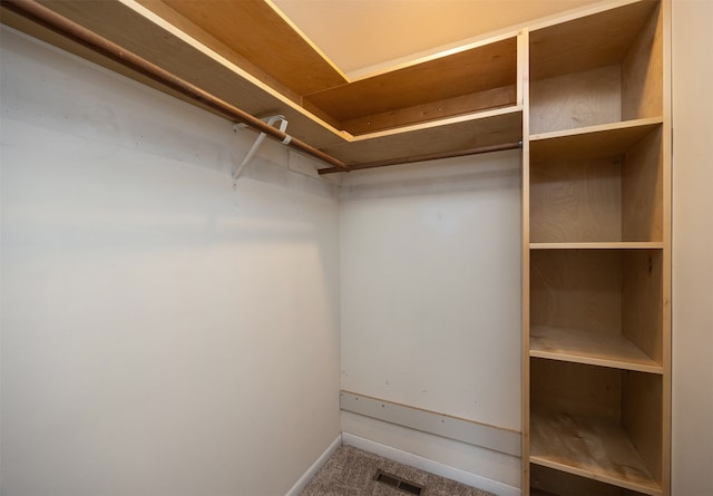 walk in closet with carpet