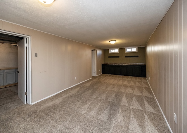 interior space featuring light carpet and a textured ceiling