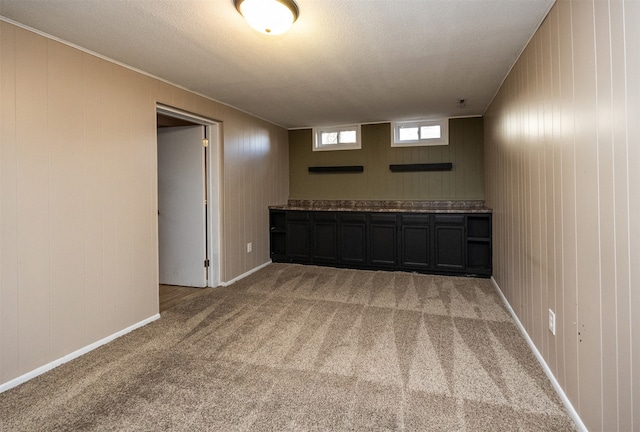 empty room featuring carpet and a textured ceiling