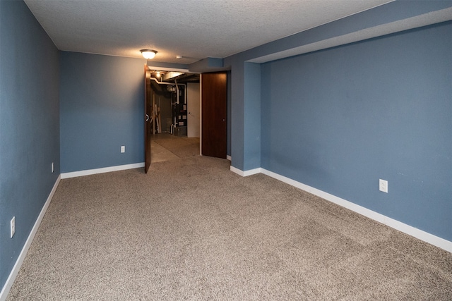 basement featuring a textured ceiling and carpet