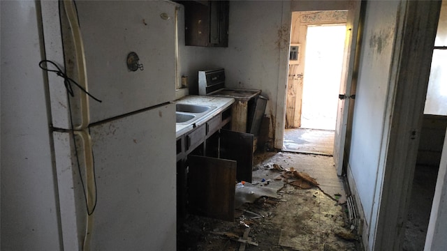 kitchen with white fridge, range, and sink